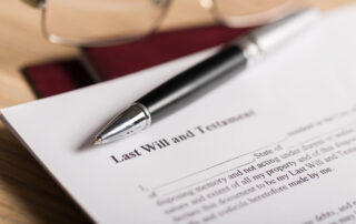 paper that says Last Will and Testament and a pen